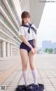 A woman in a sailor outfit is posing for a picture.