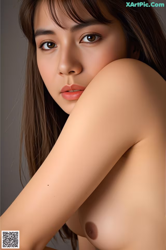 A woman with long brown hair is posing for a picture.