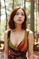 A woman in a colorful dress posing for a picture.