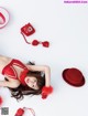 A woman in a red lingerie laying on the floor.